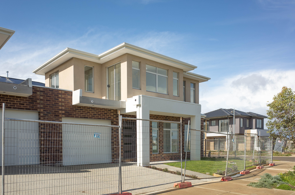 Brand,New,Residential,Townhouses,Behind,Temporary,Construction,Fences,In,An