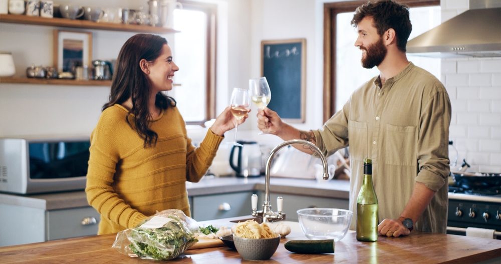 Happy,Couple,,Champagne,And,Cheers,In,Kitchen,For,Anniversary,,Date